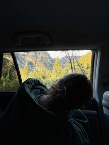 sitting in the back seat on a roadtrip to the mountains